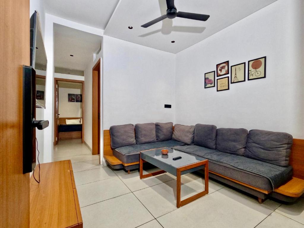 a living room with a couch and a table at Spacious 2BHK Group Stay in Vijay Nagar, Indore in Indore