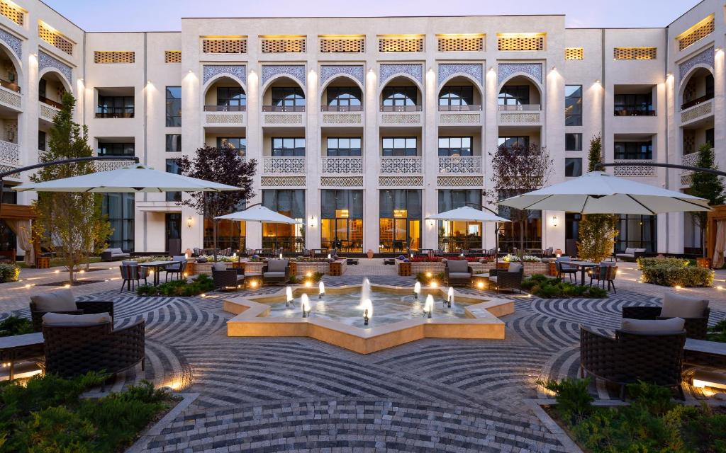 a courtyard with a fountain in front of a building at Farovon Khiva Hotel in Khiva
