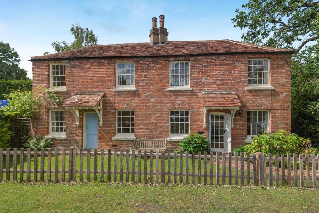 an old brick house with a wooden fence at 4 Bed in Lyndhurst oc-57407 in Lyndhurst