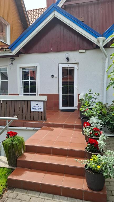 a house with stairs leading to the front door at Nida guesthouse at Loreta in Nida
