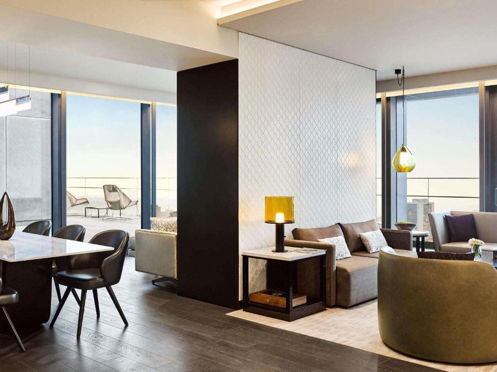 a living room with a couch and a table at Fairmont Quasar Istanbul Hotel in Istanbul