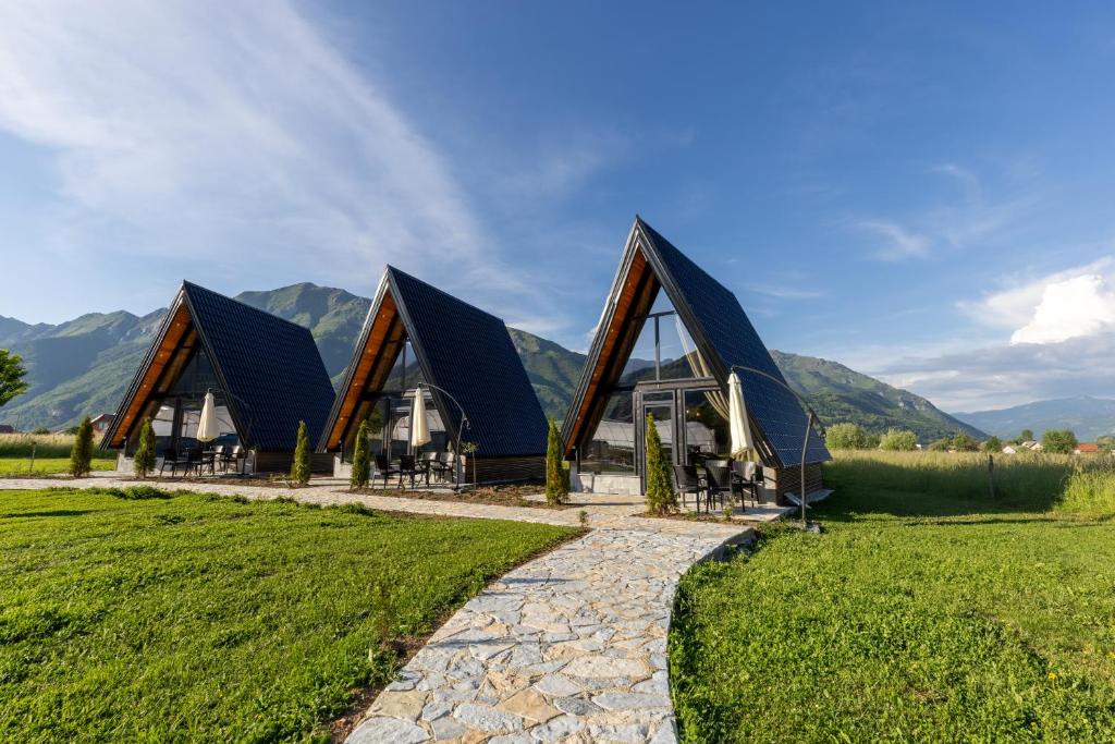 a group of three large buildings with black roofs at Ali-pašin Konak in Gusinje