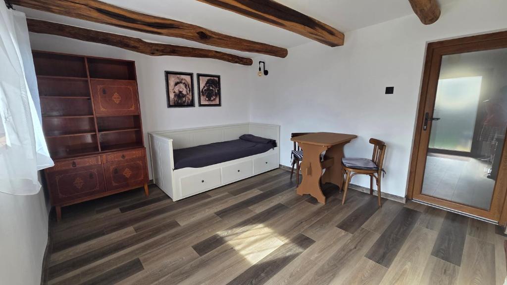 a bedroom with a bed and a desk and a table at The Nest Room in Bontida