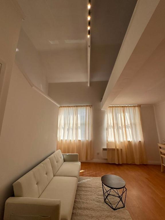 a living room with a couch and a table at Cosy 2 Story Home Leicester City Centre in Leicester