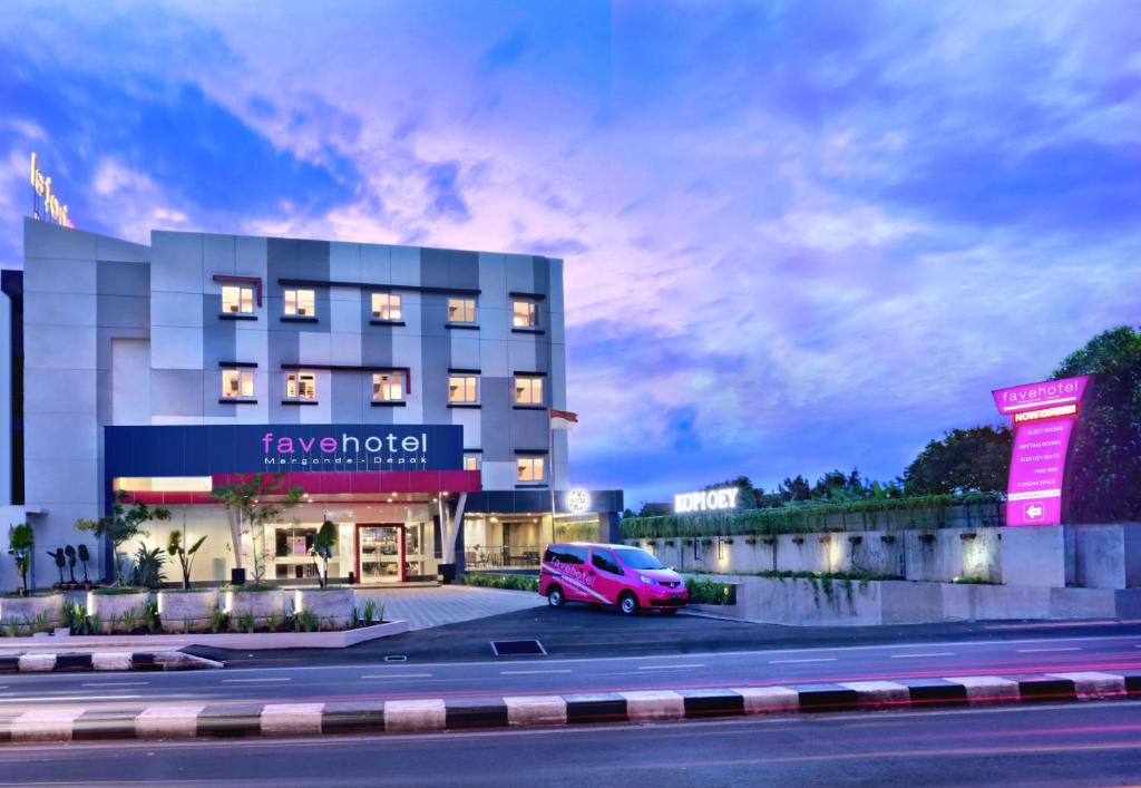 a pink van parked in front of a building at favehotel Margonda in Depok