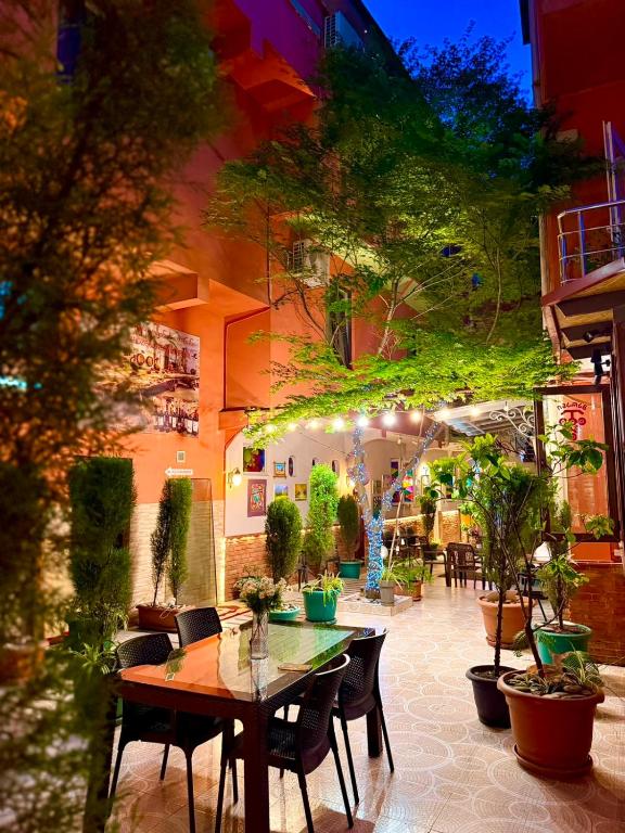 a patio with a table and chairs and plants at Marani Hotel in Batumi