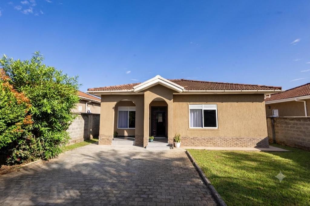 a house with a driveway in front of it at SereneKey Stays in Kigo