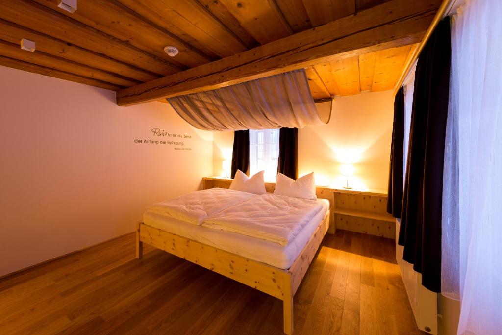 a bedroom with a bed in a room with windows at himmlisch urlauben St. Nikolai in Sankt Nikolai im Sölktal