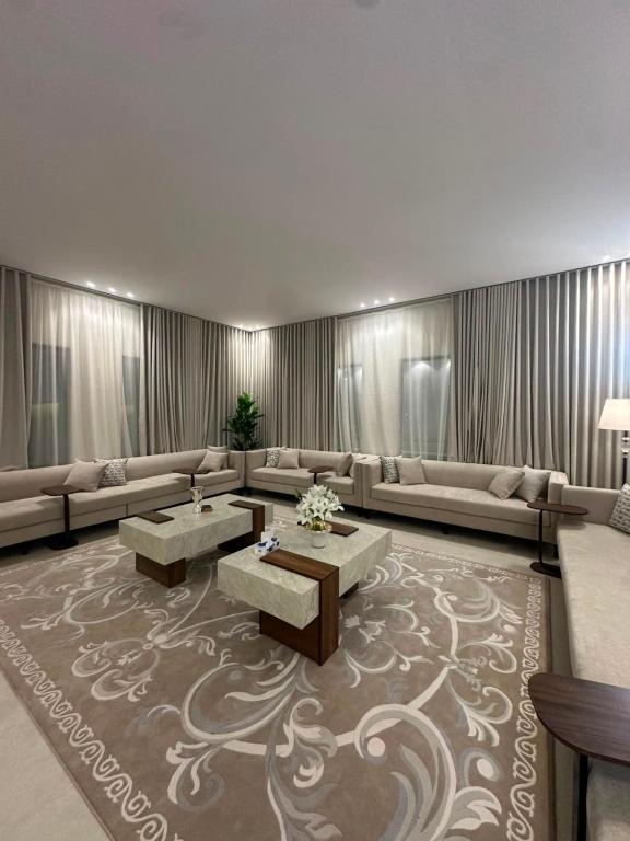 a living room with couches and tables on a rug at شاليهات أفق in Jeddah