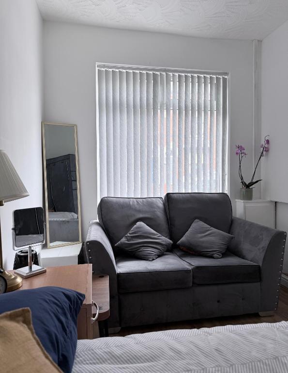 a living room with a couch in front of a window at Dream easy in Birmingham