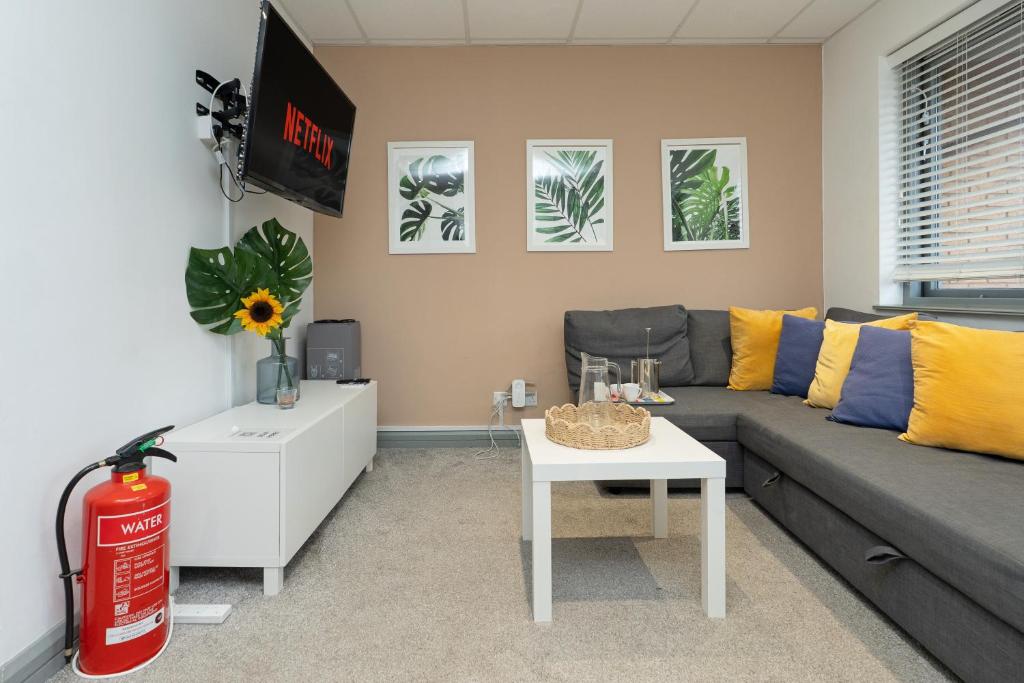 a living room with a couch and a table at Open Mind Property - Spacious 2BR Flat City Views in Portsmouth