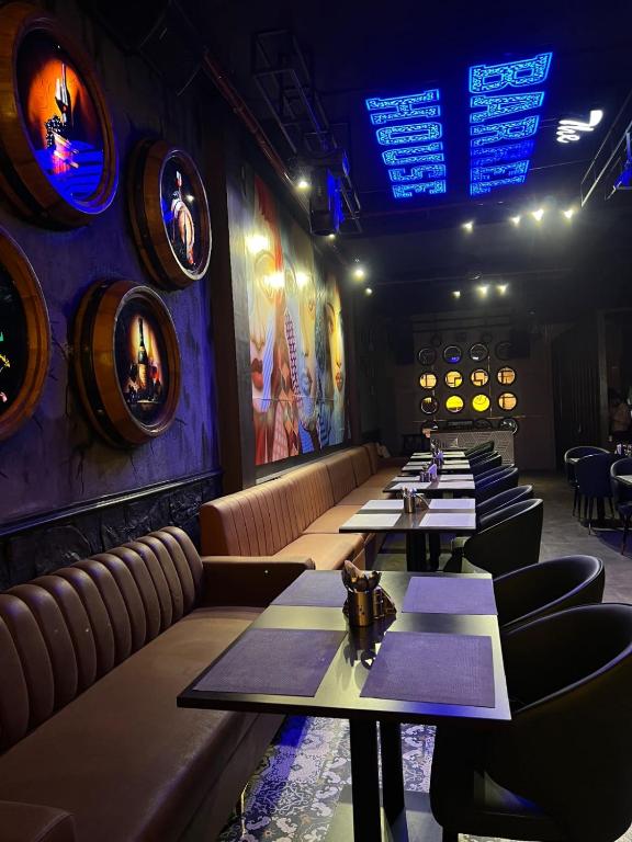 a row of tables in a restaurant with wine barrels at The Barrel House, Varanasi in Varanasi