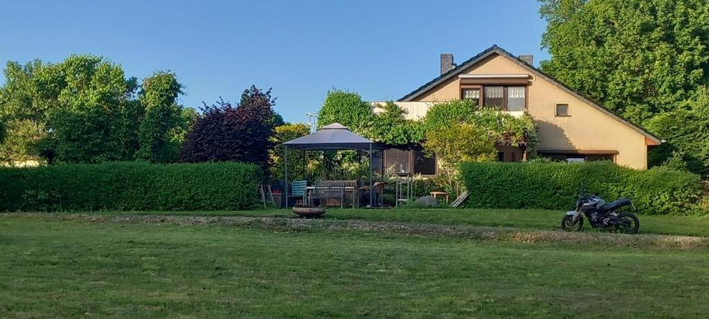 a house with a motorcycle parked in the yard at Landgut Pinnow in Murchin