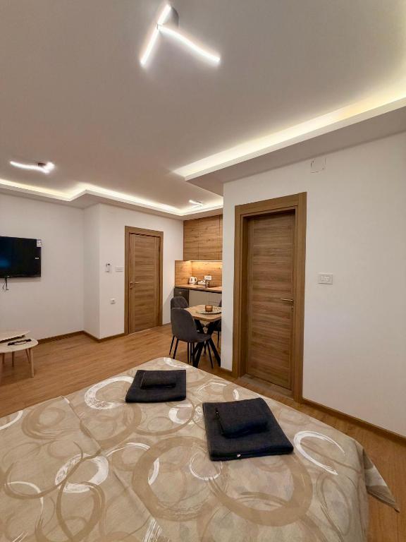 a room with two meditation mats on top of a large room at Taca 1 - Airport apartman in Surčin