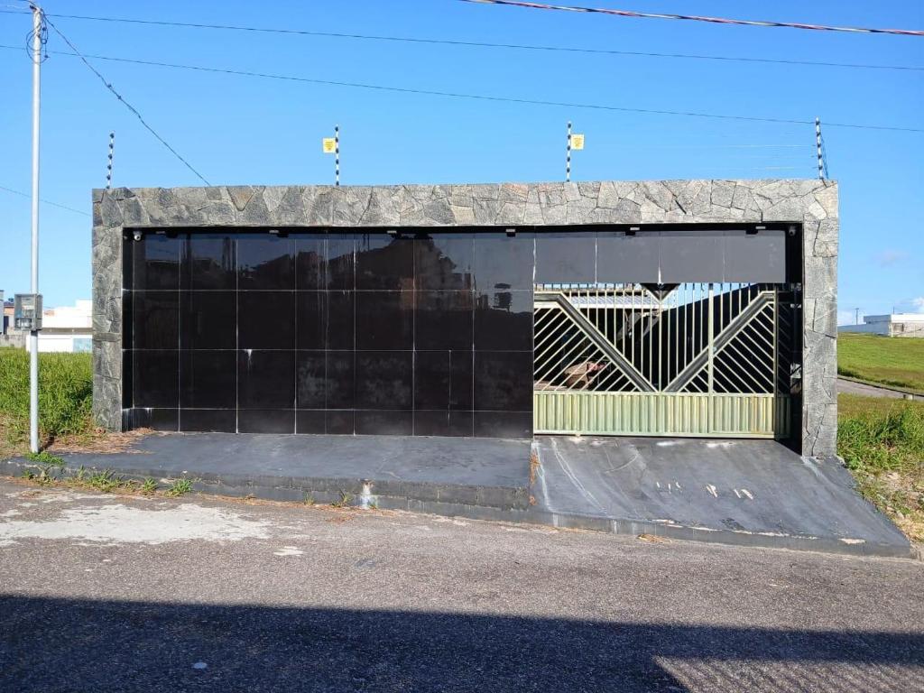 a large garage with a yellow and black door at Casa Vale do Sal 2 in Salinópolis