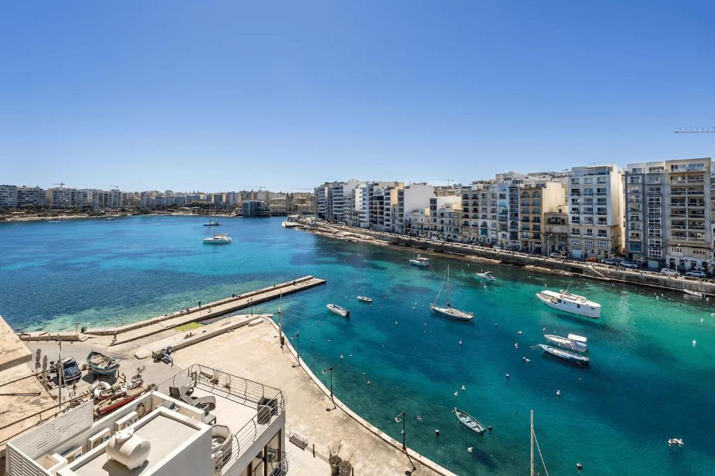 a view of a harbor with boats in the water at Spinola Seafront Deluxe in St. Julianʼs