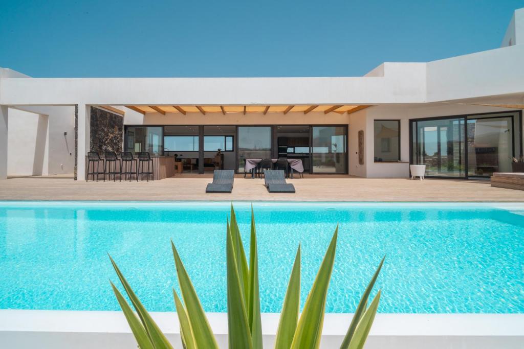 a villa with a swimming pool and a house at Villa Karuna by Aura Collection in Villaverde