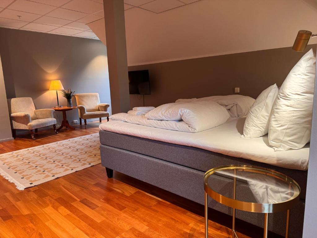 a bedroom with a bed and a table and chairs at Øvre Sem Gård in Asker