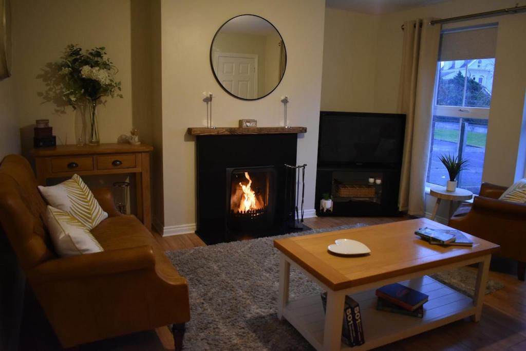a living room with a fire in the fireplace at Murlough View in Dundrum