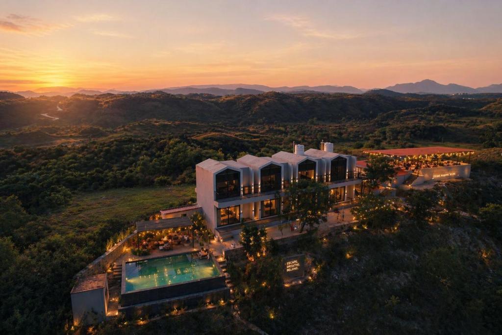an aerial view of a building with a pool at VANVASS - A Forest Resort By Rovers in Rāma