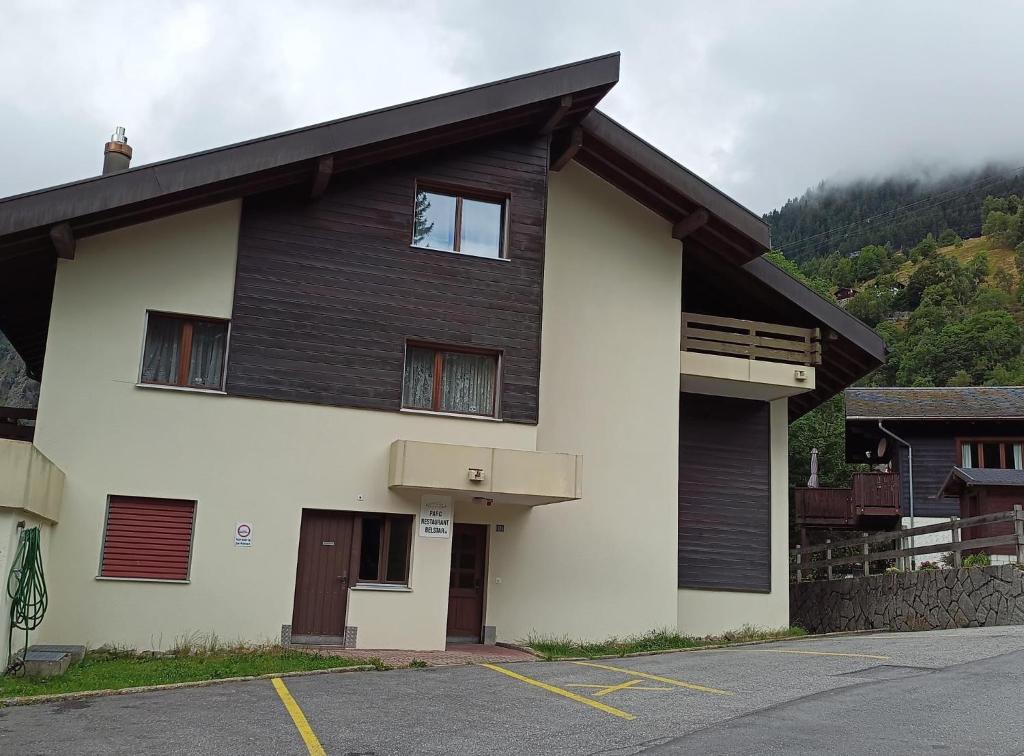 a black and white building with a parking lot at Haus Belstar A in Naters