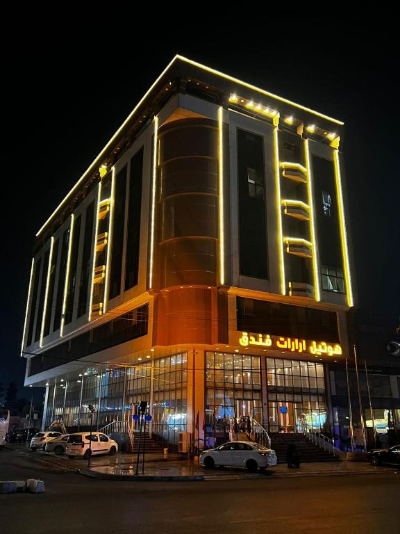 a building with cars parked in front of it at night at Hotel Ararat in Erbil