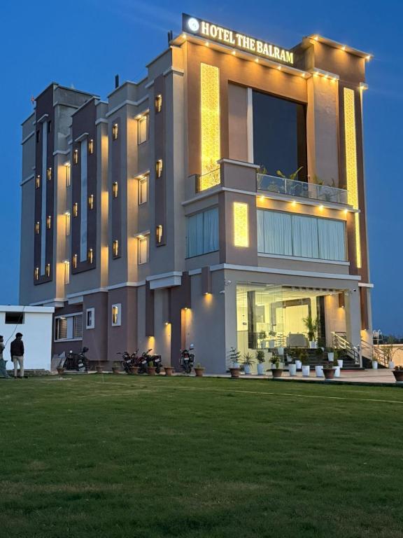 a hotel the balmoral with a lawn in front of it at Hotel The Balram in Ayodhya