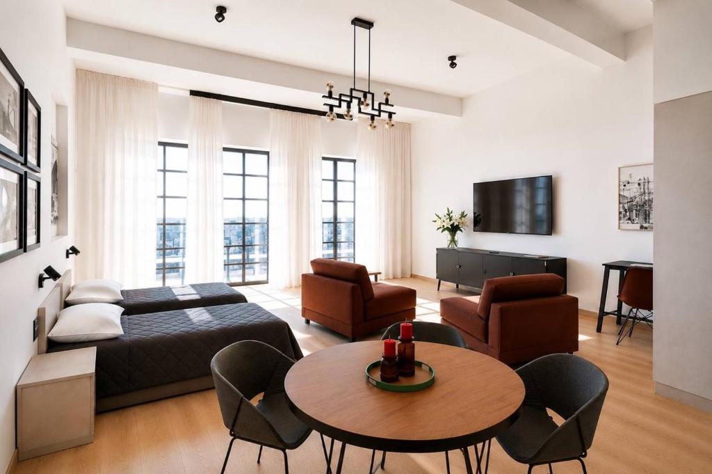 a living room with a bed and a table and chairs at Filosoofi Suites in Tartu