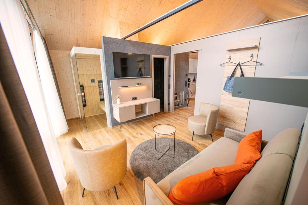 a living room with a couch and a table at Felsenland Bergvillen in Dahn