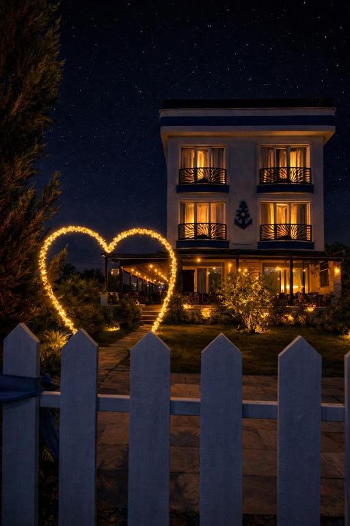 a house with a heart sign in front of it at NOVA PORT Boutique Hotel in Tekirdağ