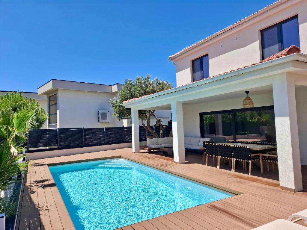a swimming pool in the backyard of a house at Vila Esnella - Private Pool & Panoramic Sea view in Primošten