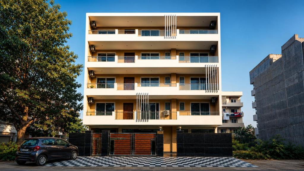 a building with a car parked in front of it at CORPORATE STAYS-Golf Course Road in Gurgaon