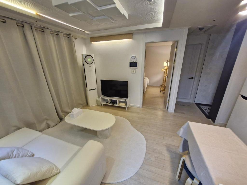a living room with a white couch and a tv at 화곡역 에스엠파크빌 in Seoul