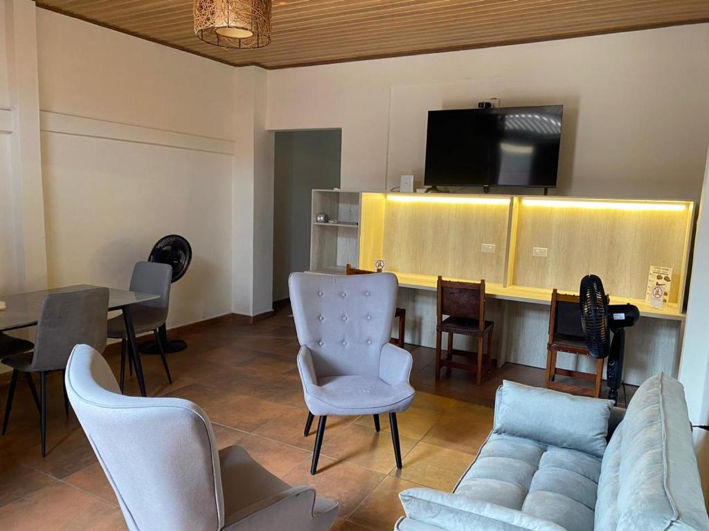 a living room with a couch and chairs and a table at La Villa Study & Relax Apartment in Los Santos