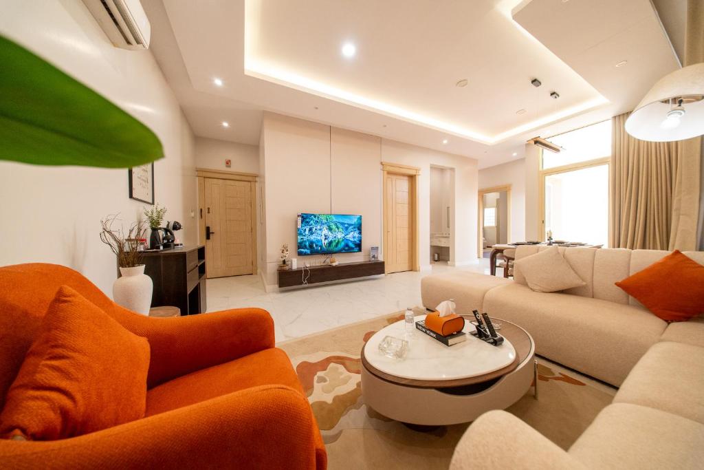 a living room with a couch and a tv at شقق مودرن مقابلة البوليفارد in Riyadh