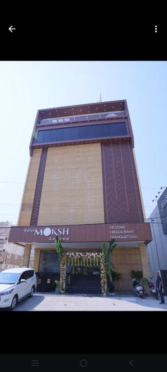 a building with a car parked in front of it at MOKSH SERENe in Shrīnagar