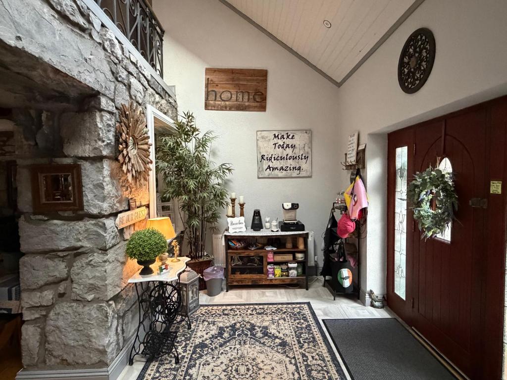 a hallway with a stone wall and a door at Salmon Weir Lodge in Cong