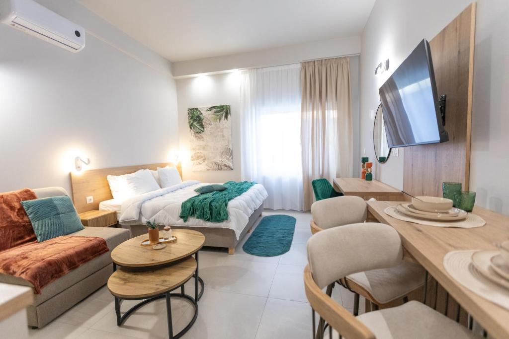 a hotel room with a bed and a living room at Breeze Apartments Megara - Echo in Megara
