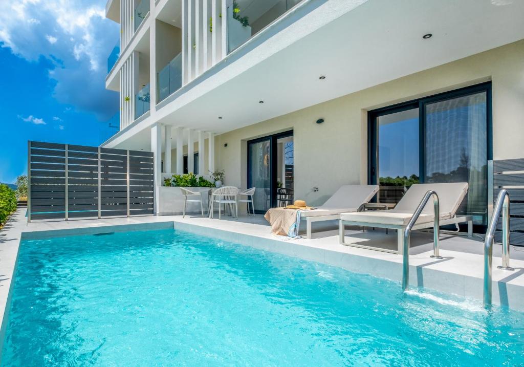 a house with a swimming pool and a patio at Calista Horizon by Booking Kottas in Kallithea Halkidikis