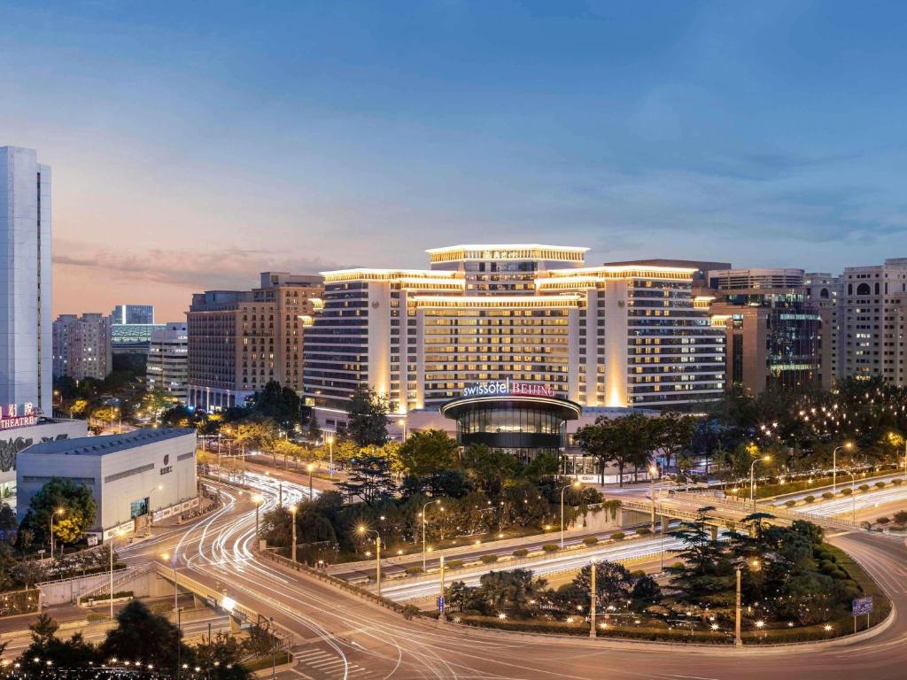 a city at night with a highway and buildings at Swissotel Beijing Hong Kong Macau Center in Beijing
