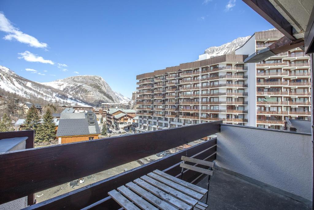 a balcony of a building with a bench on the roof at Résidence les Cimes - Centre Val d'Isère in Val-d'Isère