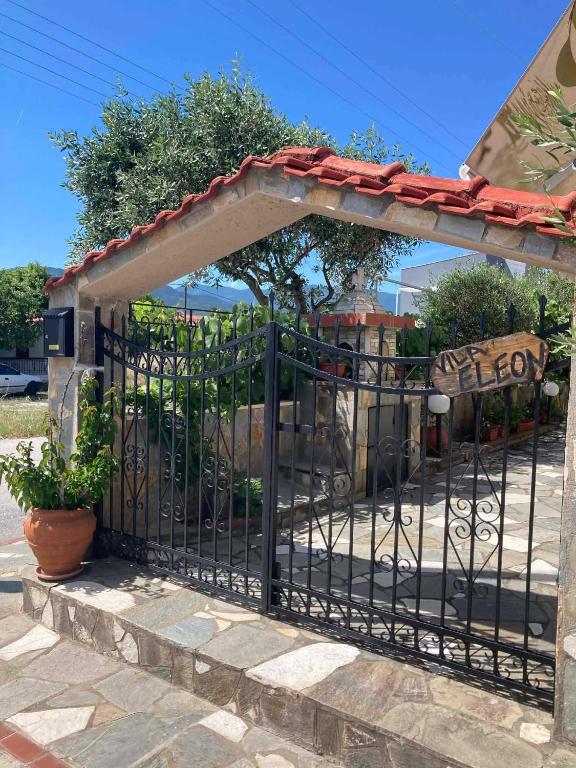 a black gate with a stone wall at Villa Eleon 2 in Nea Vrasna