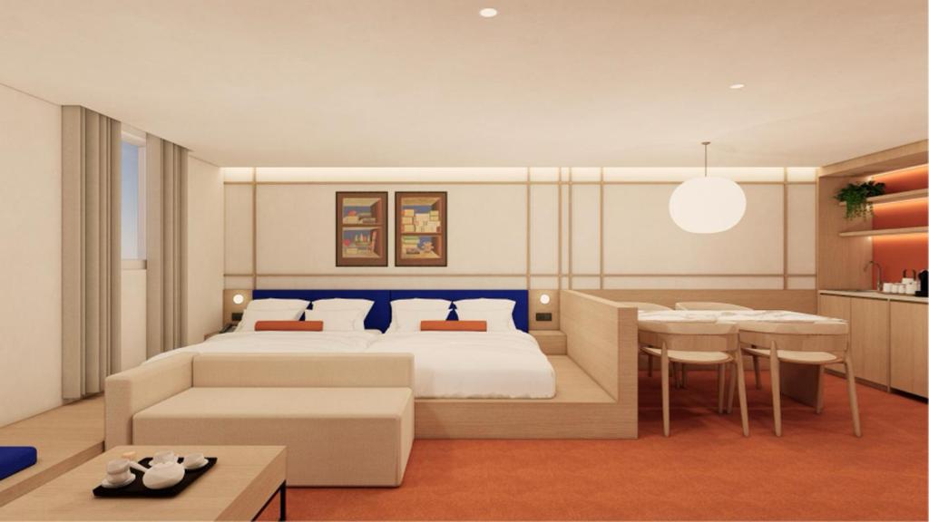 a bedroom with a bed and a dining room at Hotel Inspiroom Jongro in Seoul