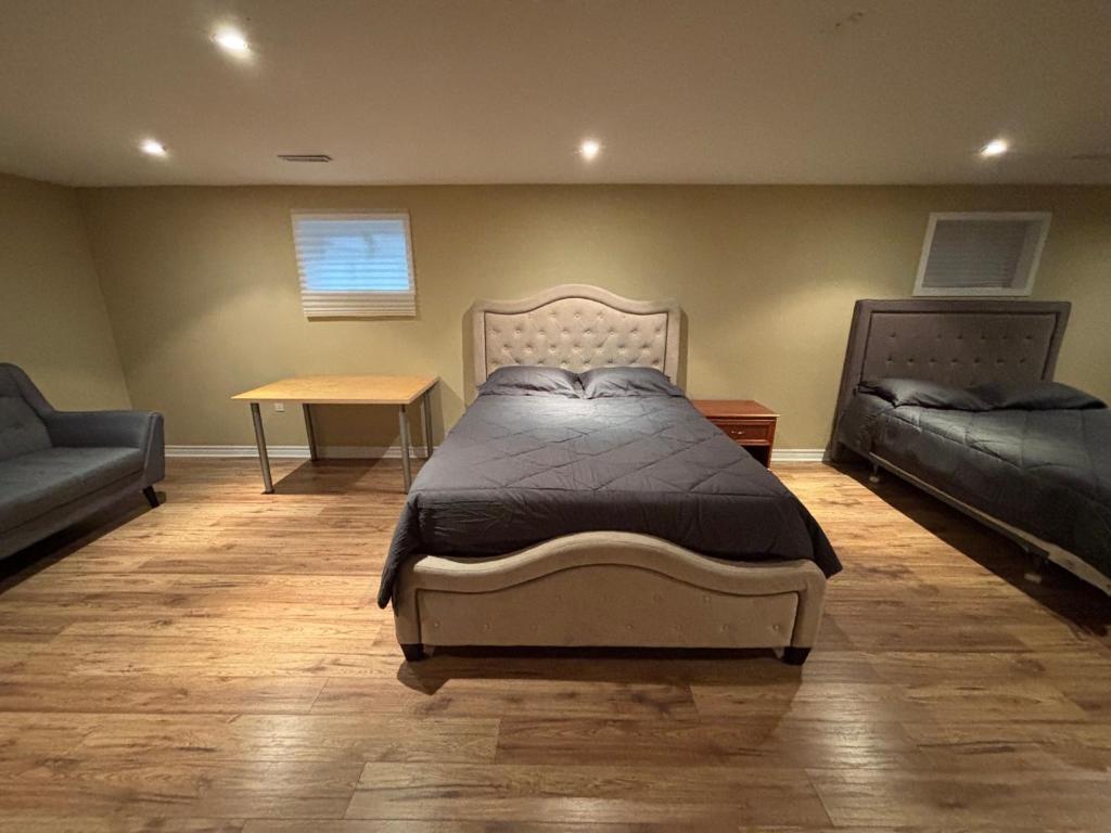 a bedroom with a bed and a couch and a table at House in Markham in Markham