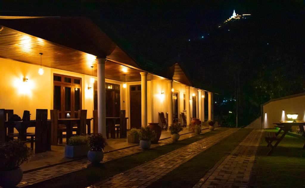 a building with lights on it at night at Zenora Villa ella in Ella
