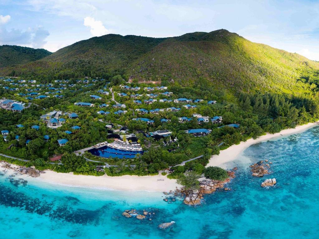 an aerial view of a resort on a beach at Raffles Seychelles in Baie Sainte Anne
