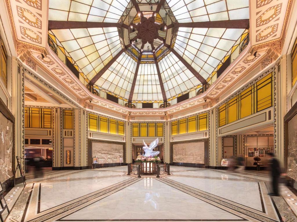 a large building with a glass ceiling and a dance floor at Fairmont Peace Hotel on the Bund in Shanghai