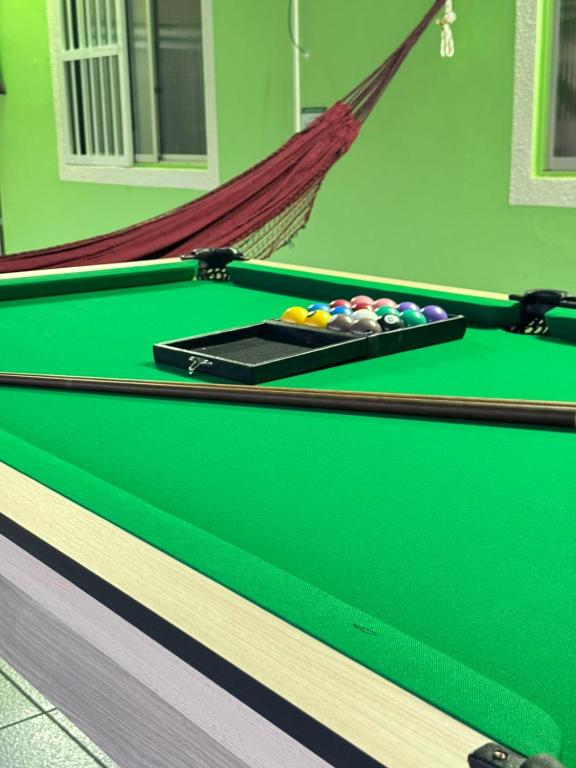 a green snooker table with balls on it at Casa Verde Mar com Sinuca in Barra Velha