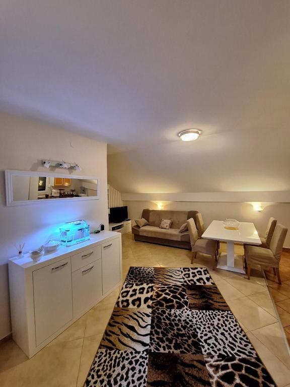 a living room with a couch and a table at MÐM Duplex Apartment in Podgorica