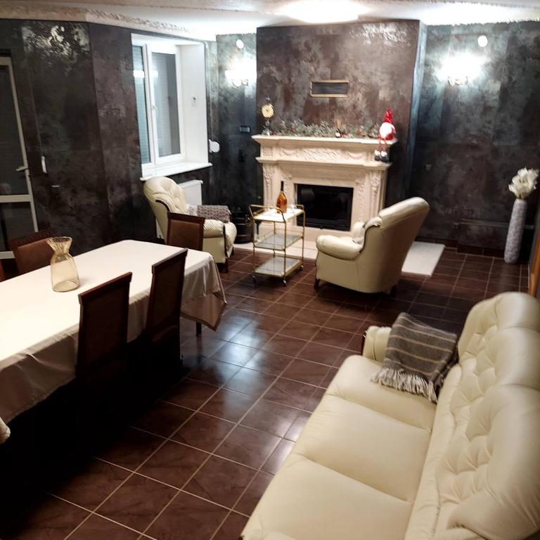 a living room with white furniture and a fireplace at Оксамитове ретро in Ternopil